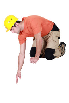 Construction Worker Reaching Down To Empty Copyspace