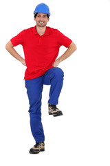 Builder with his foot on a board left blank for your message