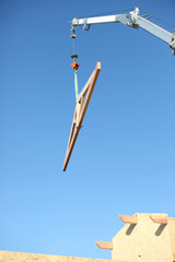 crane lifting wooden frame