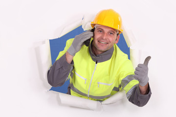 Construction worker breaking through a barrier