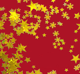 Frohe Weihnachten: Goldene Sternchen vor rotem Hintergrund