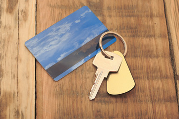 key with plastic card and reflection blue sky and clouds