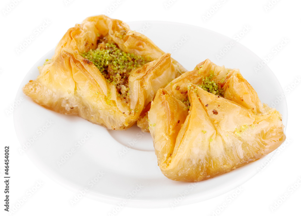 Wall mural Sweet baklava on plate isolated on white - Wall murals