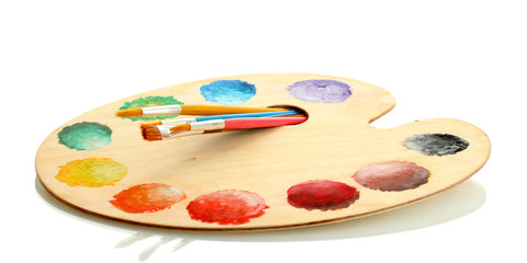 wooden art palette with paint and brushes isolated on white