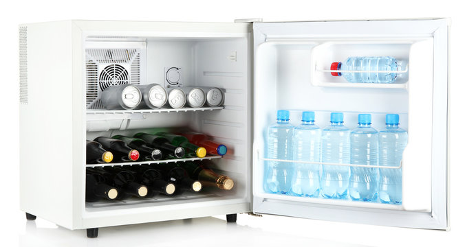 Mini fridge full of bottles of alcoholic beverages and water
