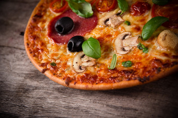 Tasty Italian pizza on wooden background