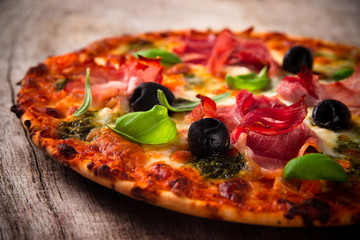 Tasty Italian pizza on wooden background