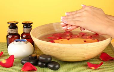 Obraz na płótnie Canvas spa treatments for female hands, on yellow background