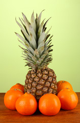 still life of fruit on a table on a green background