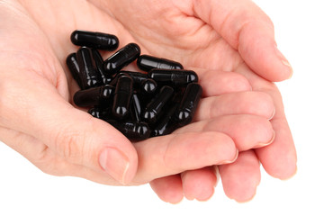 activated carbon in hands isolated on white