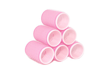 Six pink velcro rollers stacked in a pyramid