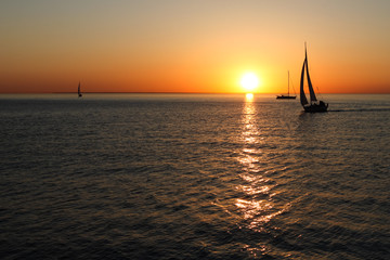 The gold silhouettes of boats at sea