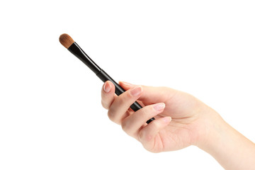 hand with black brush for make-up  isolated on white.