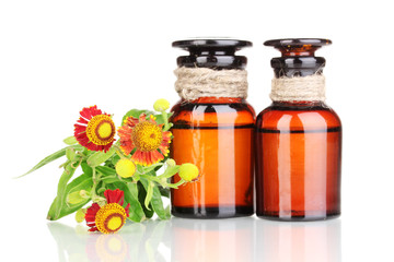 medicine bottles and flowers isolated on white