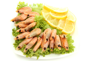 Boiled shrimps with lemon and lettuce leaves