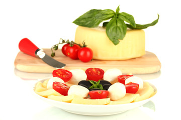 sliced mozzarella cheese with vegetables in the plate isolated