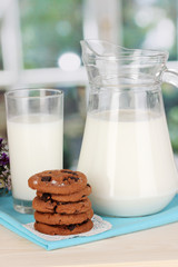 Pitcher and glass of milk with cookies