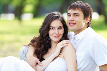 Fototapeta premium Young love Couple smiling under blue sky