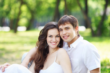 Fototapeta premium Young love Couple smiling under blue sky