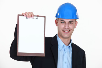 businessman wearing helmet and holding a notepad