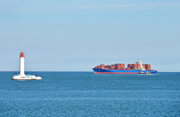 Cargo ship near lighthouse in Odessa, Ukraine