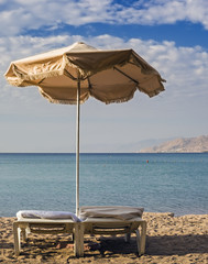 Sunshade and resting beds in sandy beach of Eilat