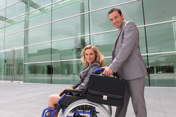 woman in a wheelchair and man helping