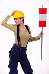 Female road-worker with sign