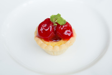Strawberry tart on white plate