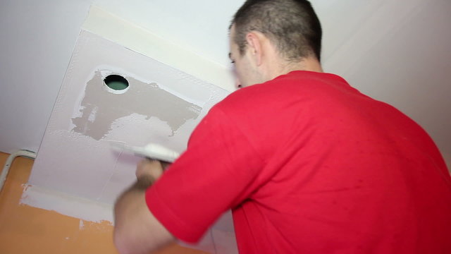 Man Applaying Plaster on a Dry Wall