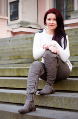 young girl sitting outside on the steps