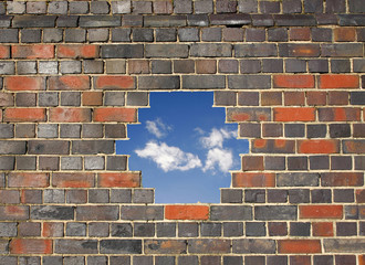 Sky through a hole in a brick wall