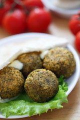 Falafel balls with pita bread,sauce,salad and tomatoes