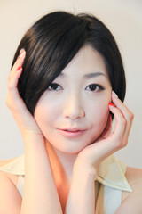 Fototapeta premium Portrait of beautiful Japanese young woman with hand