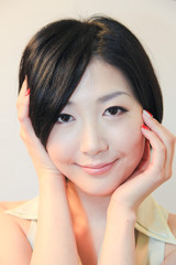Naklejka premium Portrait of beautiful Japanese young woman with hand