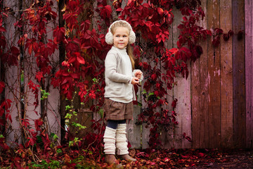 Portrait of an adorable toddler girl wearing fashion knitted clo