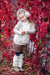 Portrait of an adorable toddler girl wearing fashion knitted clo