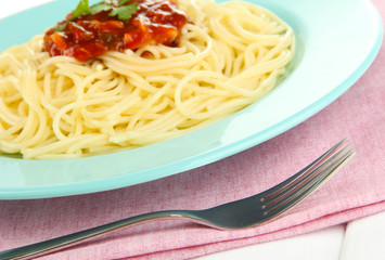 Italian spaghetti in plate on wooden table
