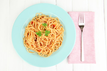 Italian spaghetti in plate on wooden table