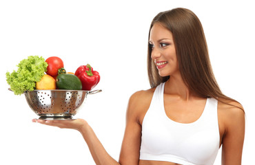 beautiful young woman with vegetables in colander, isolated