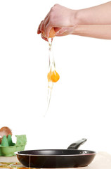 Hands breaking an egg.