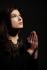 Young caucasian woman praying