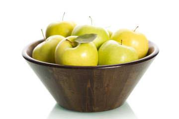 Green apples in basket, isolated.