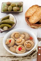 mushrooms, cucumbers, olives and toasts on the table
