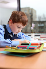 beautiful little boy sitting at the table