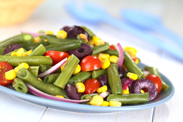 Green bean salad with tomato, corn, olive and onion