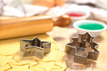 Baking Christmas Cookies: Cookie cutter on rolled out  dough