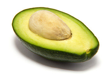 half avocado with stone on a white background