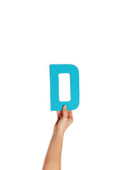 hand holding up the letter D from the bottom