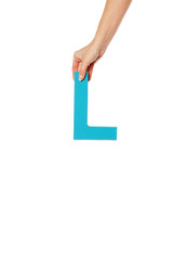 hand holding up the letter L from the top
